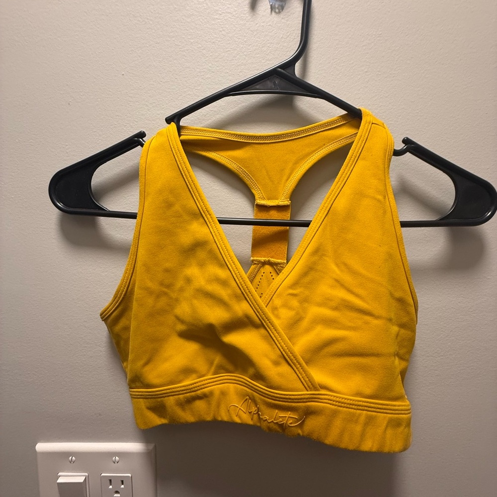 ALPHALETE: Mustard yellow sports bra
